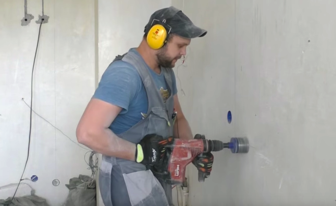 drilling holes for flush mounts in a concrete wall